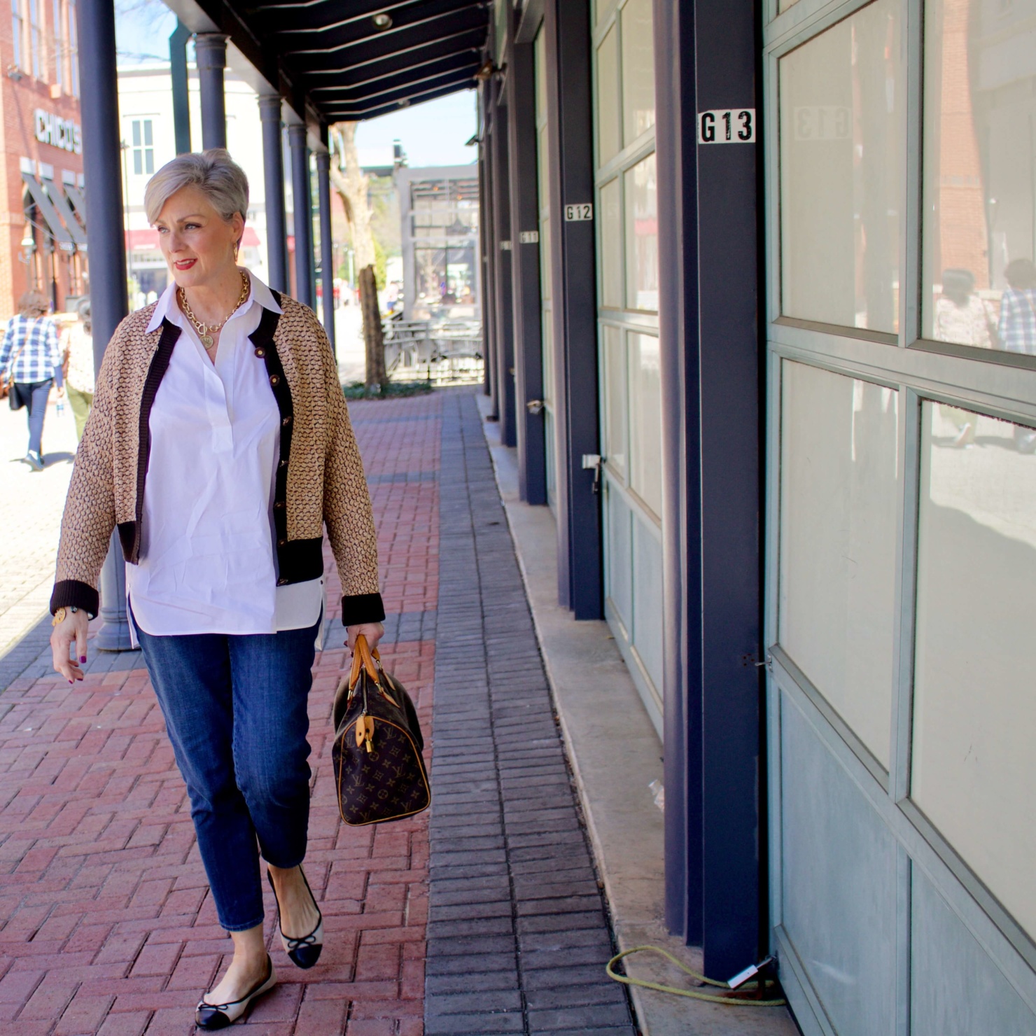 beth from Style at a Certain goes shopping  wearing a Lafayette 148 white shirt, St. John Sport sweater, girlfriend jeans, and ballet flats