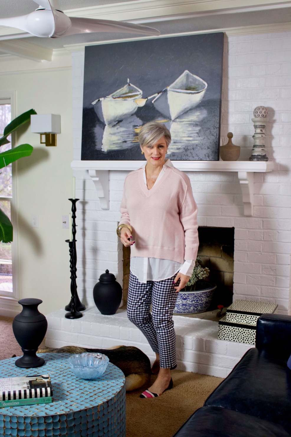 beth from Style at a Certain Age wears a paloma pink sweater with white underlay, gingham pants, and pointy toe flats