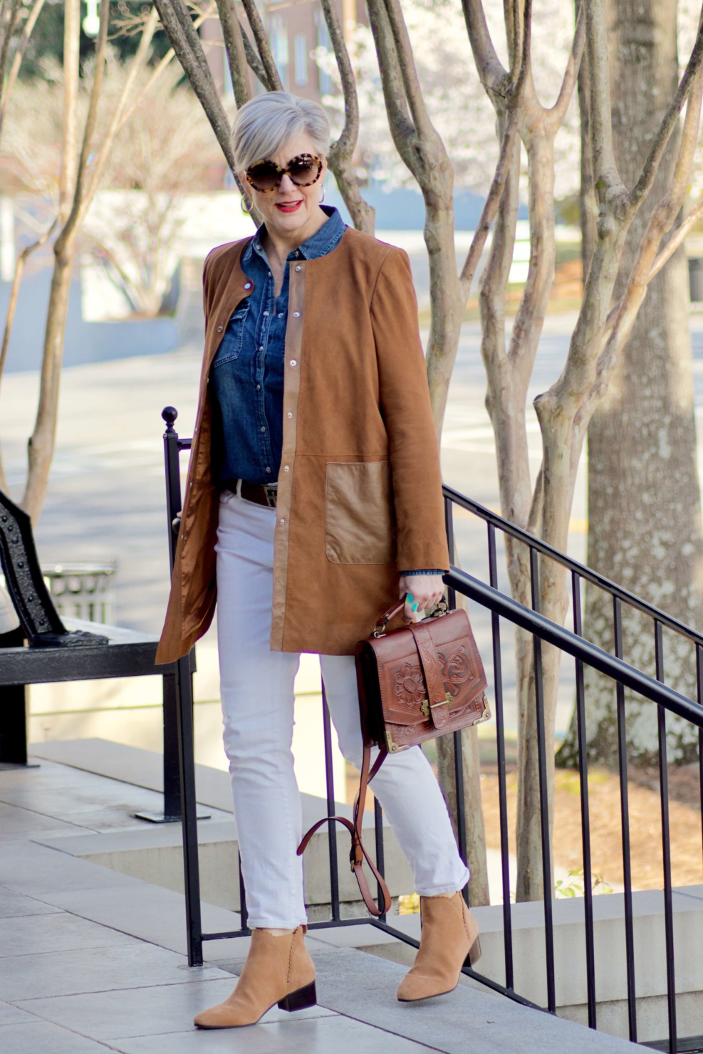 beth from Style at a Certain Age wears white denim, chambray shirt, suede jacket and booties