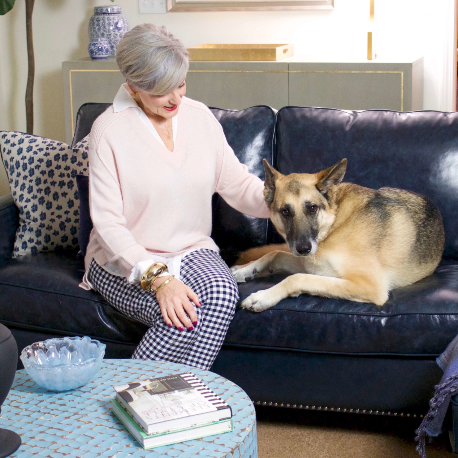 beth from Style at a Certain Age wears a paloma pink sweater with white underlay, gingham pants, and pointy toe flats