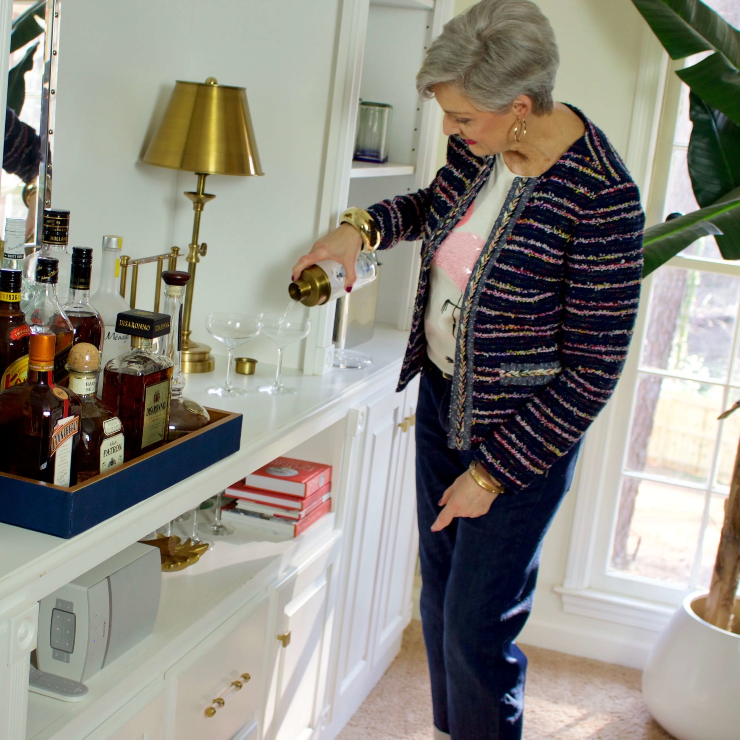 beth from Style at a Certain Age wears boyfriend jeans, graphic tee, tweed blazer and pink kitten heels