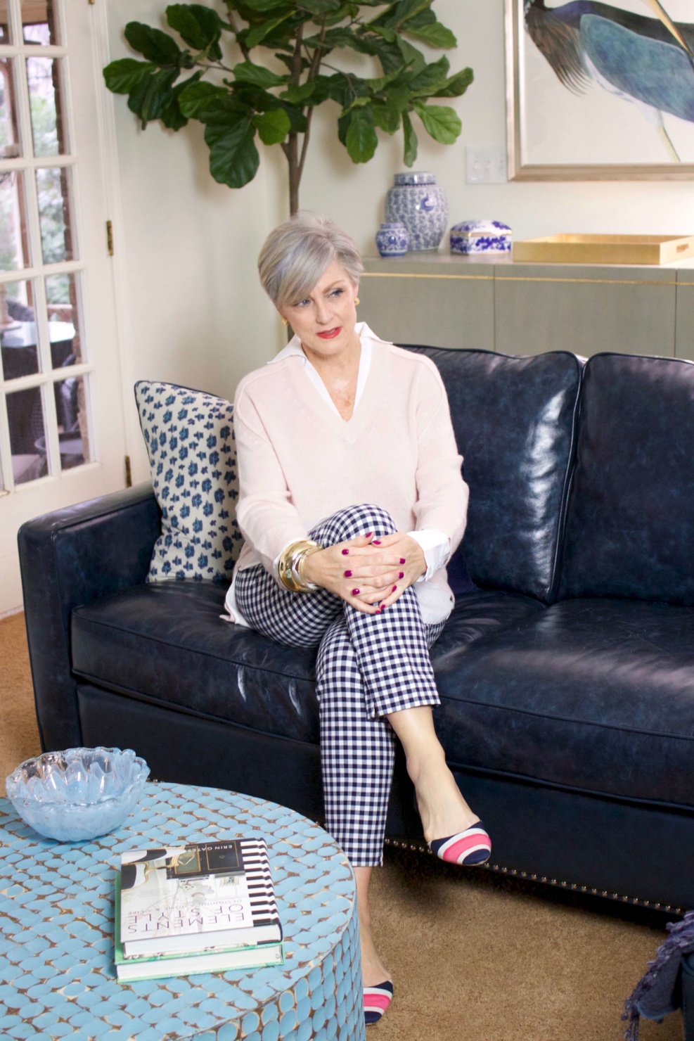 beth from Style at a Certain Age wears a paloma pink sweater with white underlay, gingham pants, and pointy toe flats