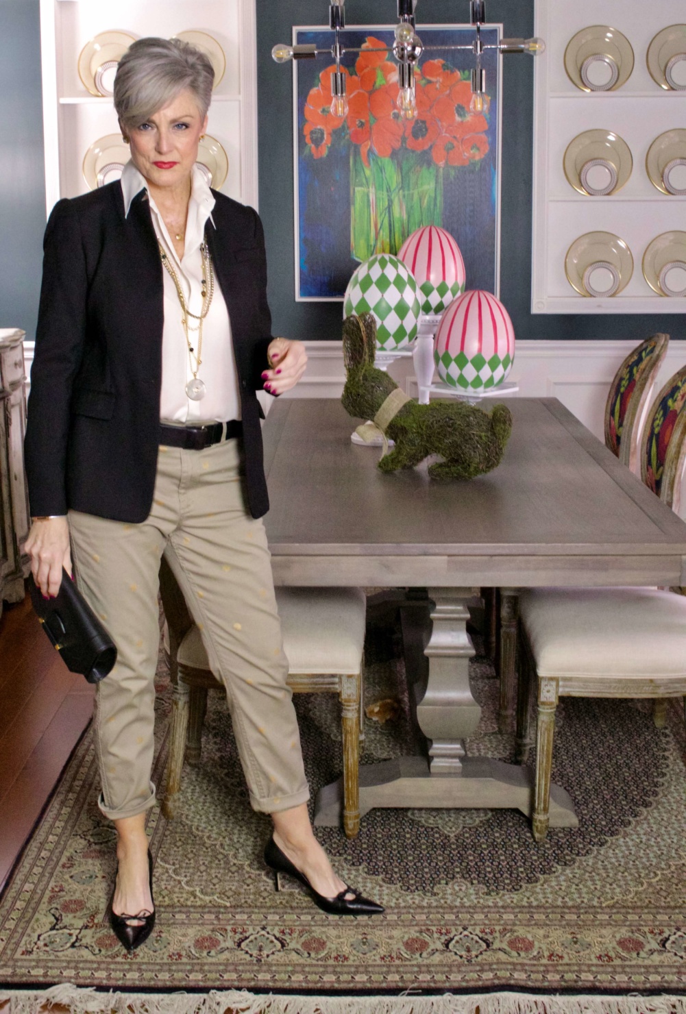 beth from Style at a Certain Age wears J.Crew chinos, black blazer, ivory silk blouse, black pumps and black clutch handbag