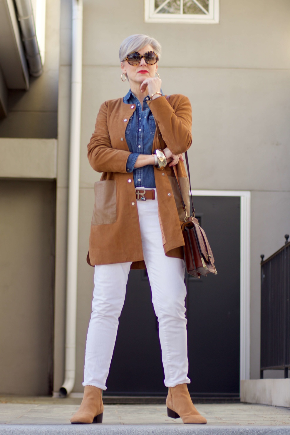 beth from Style at a Certain Age wears white denim, chambray shirt, suede jacket and booties