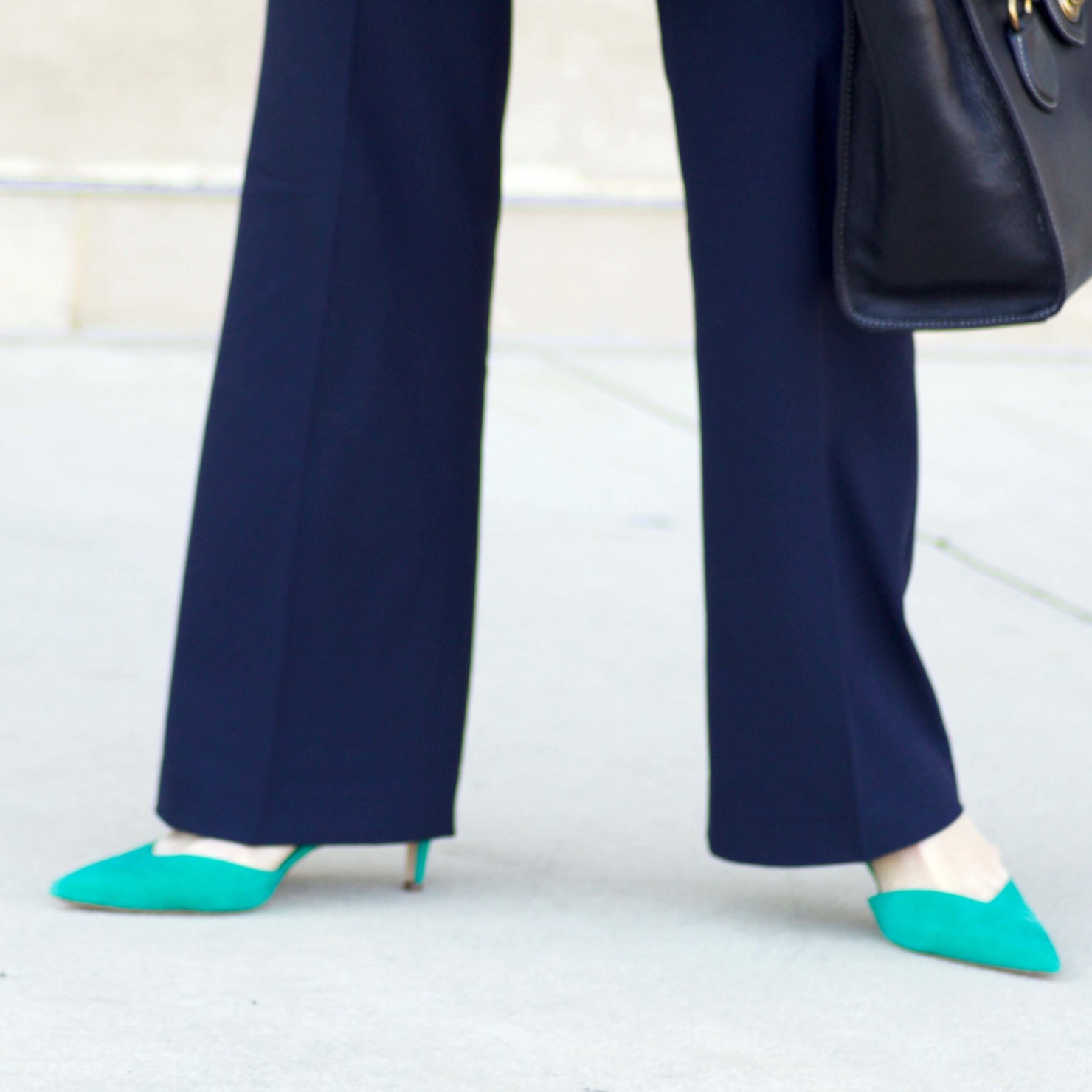 beth from Style at a Certain Age wears a Ann Taylor green trench coat, navy trousers, white essential shirt, knit striped blazer, and green suede pumps.