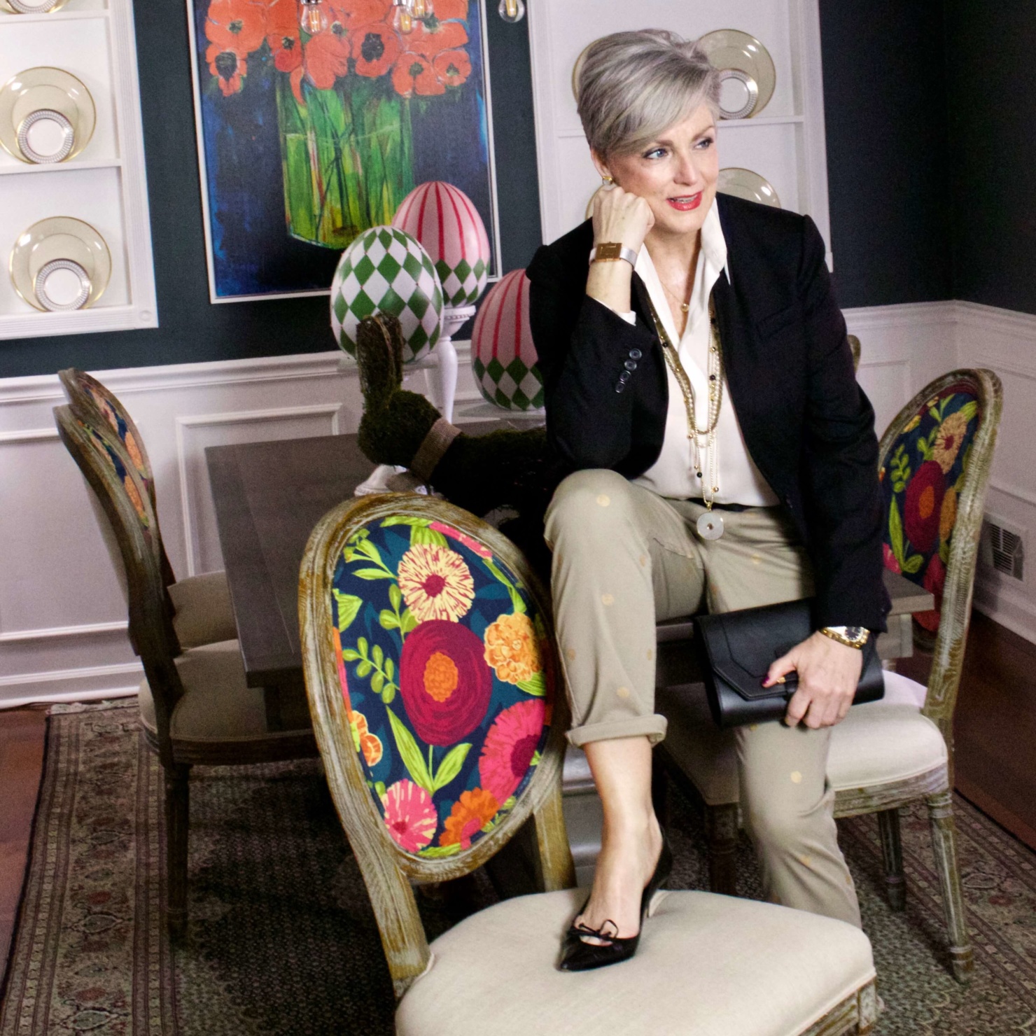 beth from Style at a Certain Age wears J.Crew chinos, black blazer, ivory silk blouse, black pumps and black clutch handbag