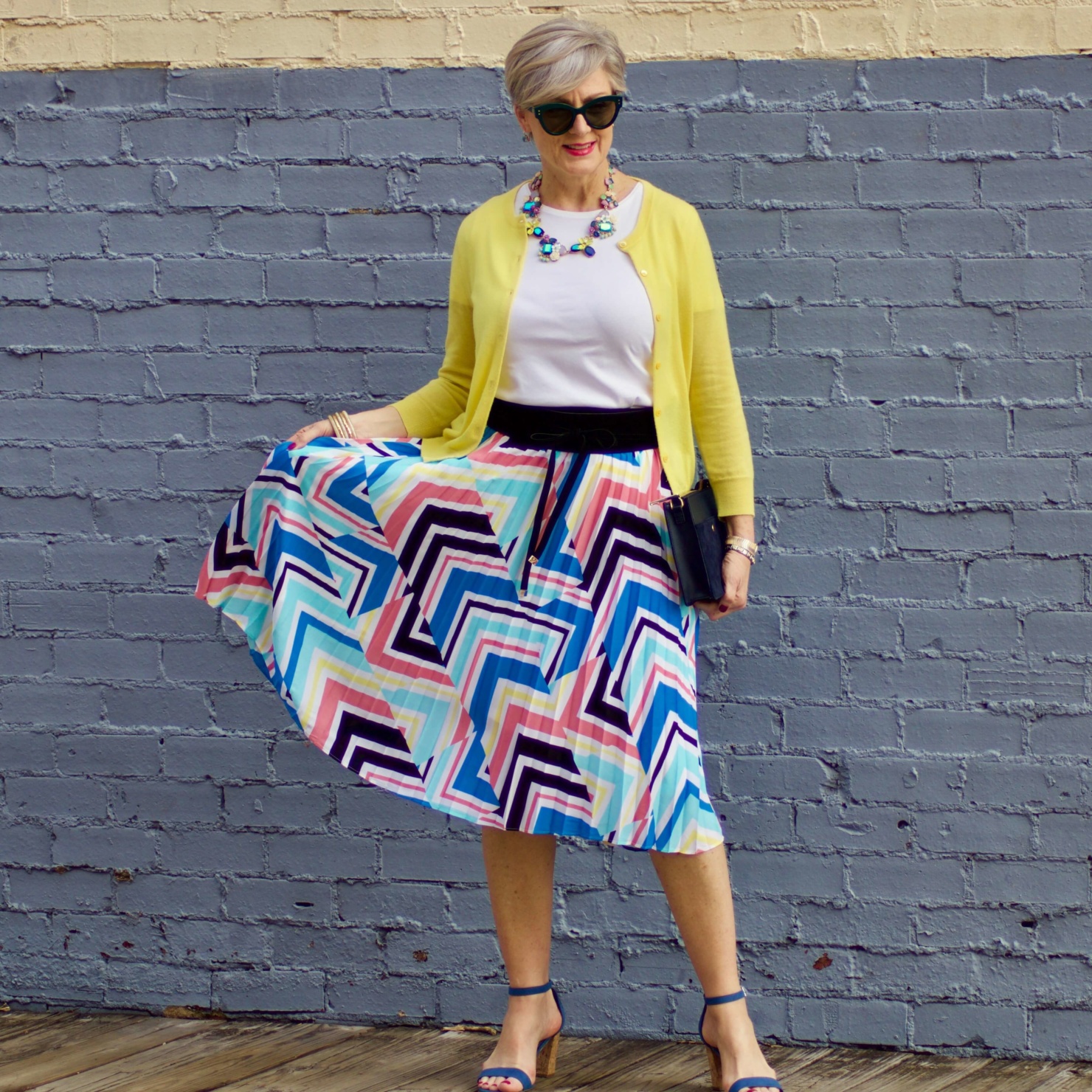 beth from Style at a Certain Age wears a midi skirt from J.C. Penney, white tee, and yellow cardigan