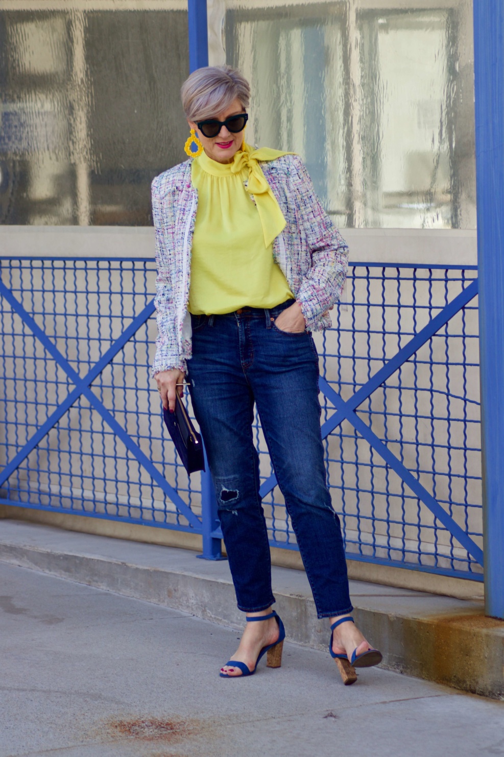 beth from Style at a Certain Age wears a tweed jacket from JC Penney, yellow tie blouse, distressed denim and sandals