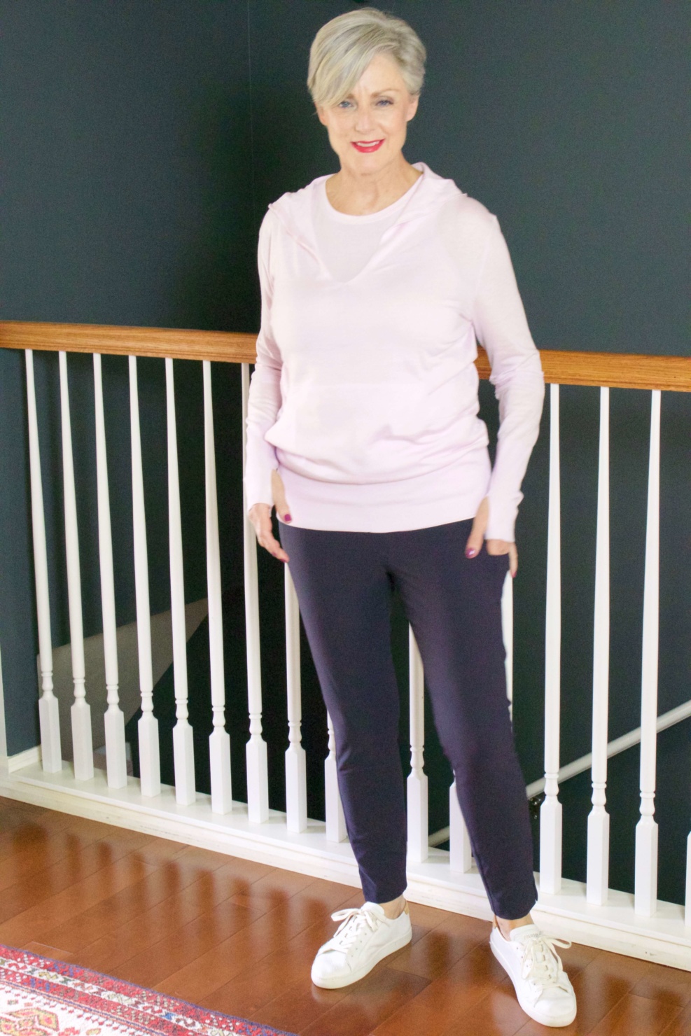 beth from Style at a Certain Age wears travel style Athleta wander slim pants, essence vital tank, and enlighten sweater hoodie