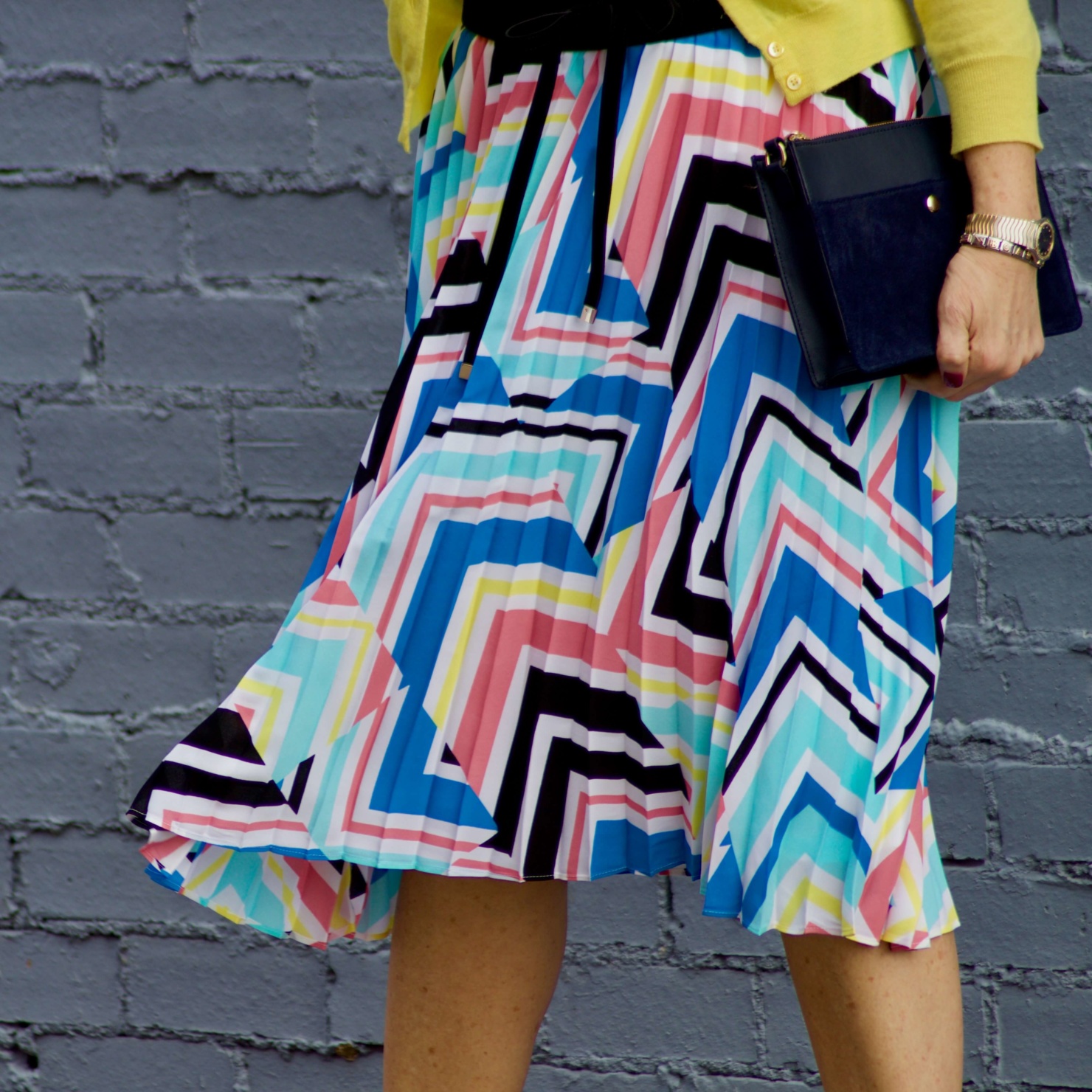 beth from Style at a Certain Age wears a midi skirt from J.C. Penney, white tee, and yellow cardigan