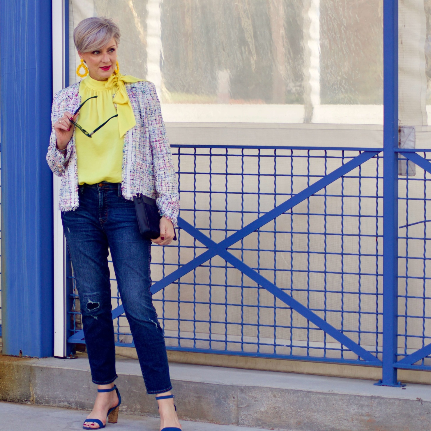 beth from Style at a Certain Age wears a tweed jacket from JC Penney, yellow tie blouse, distressed denim and sandals