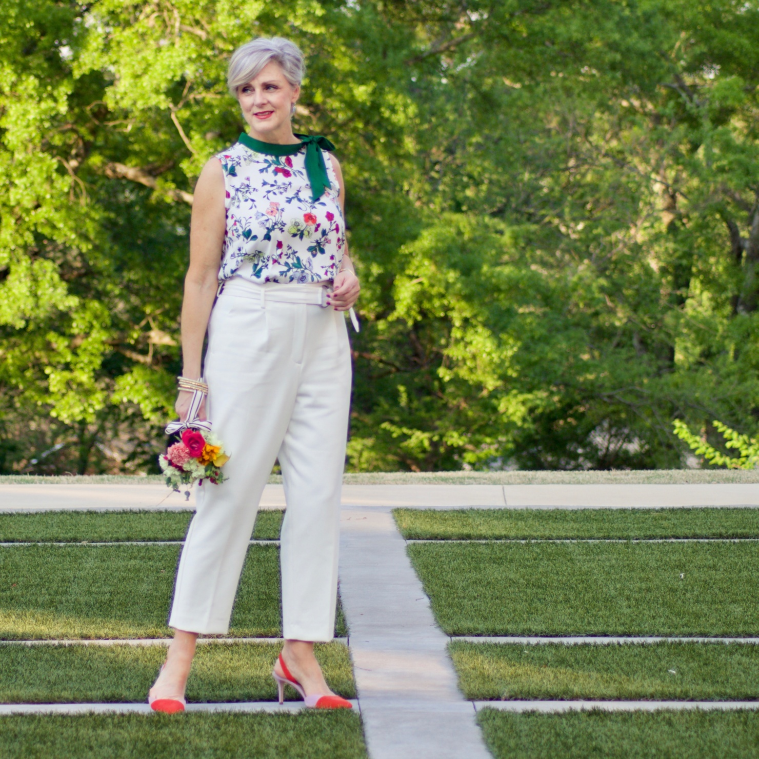 beth from Style at a Certain Age wears Ann Taylor floral tie neck blouse, pleated pants and suede slingbacks