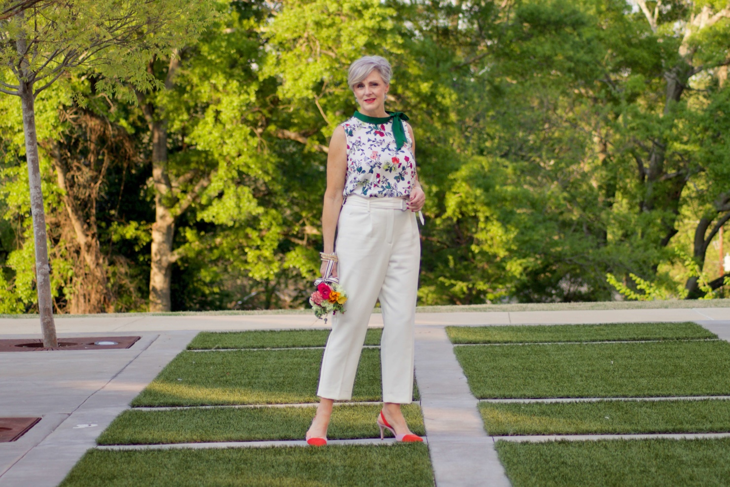 beth from Style at a Certain Age wears Ann Taylor floral sleeveless tie neck blouse, pleated pants, textured blazer, and suede slingbacks