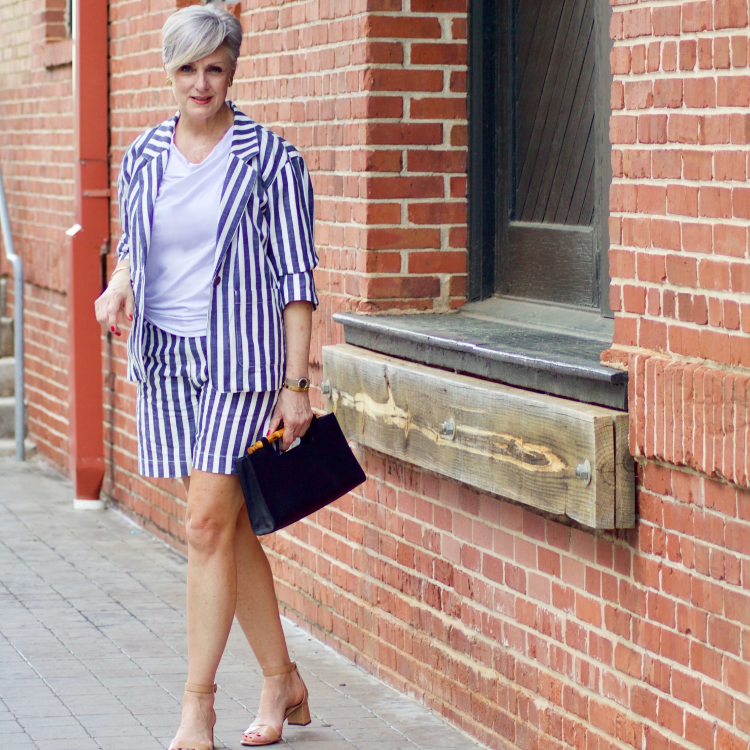 beth from Style at a Certain Age wears striped shorts, striped blazer, white tee, nude block heels