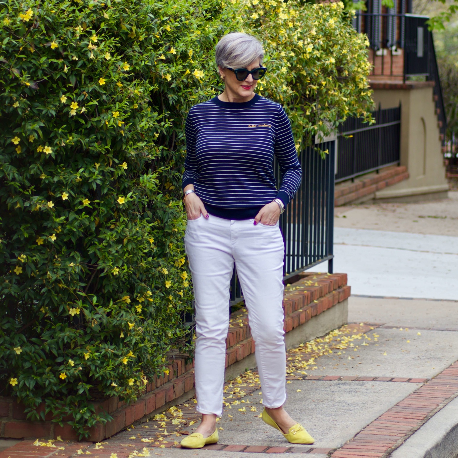 beth from Style at a Certain Age wears a striped sweater and white denim