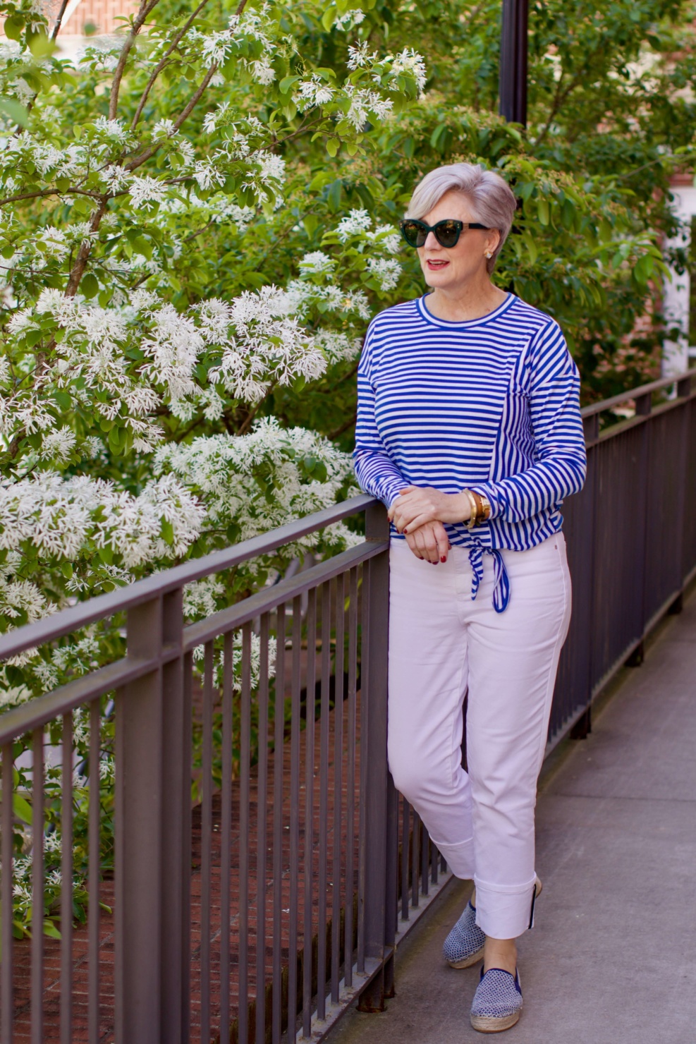 beth from Style at a Certain Age wears white denim, blue and white striped tee, platform espadrilles