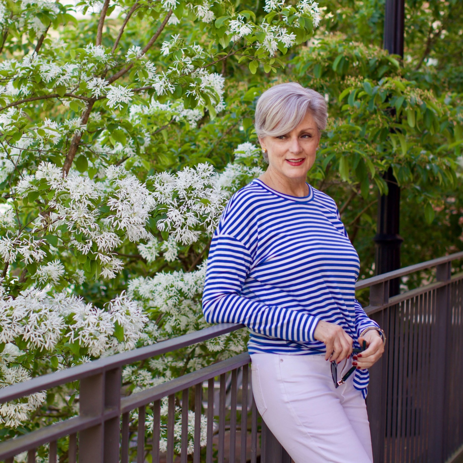 beth from Style at a Certain Age wears white denim, blue and white striped tee, platform espadrilles