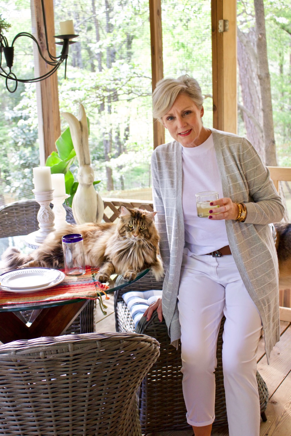 beth from Style at a Certain Age wears white girlfriend chinos, white muscle tee, gray cardigan, and brown sandals
