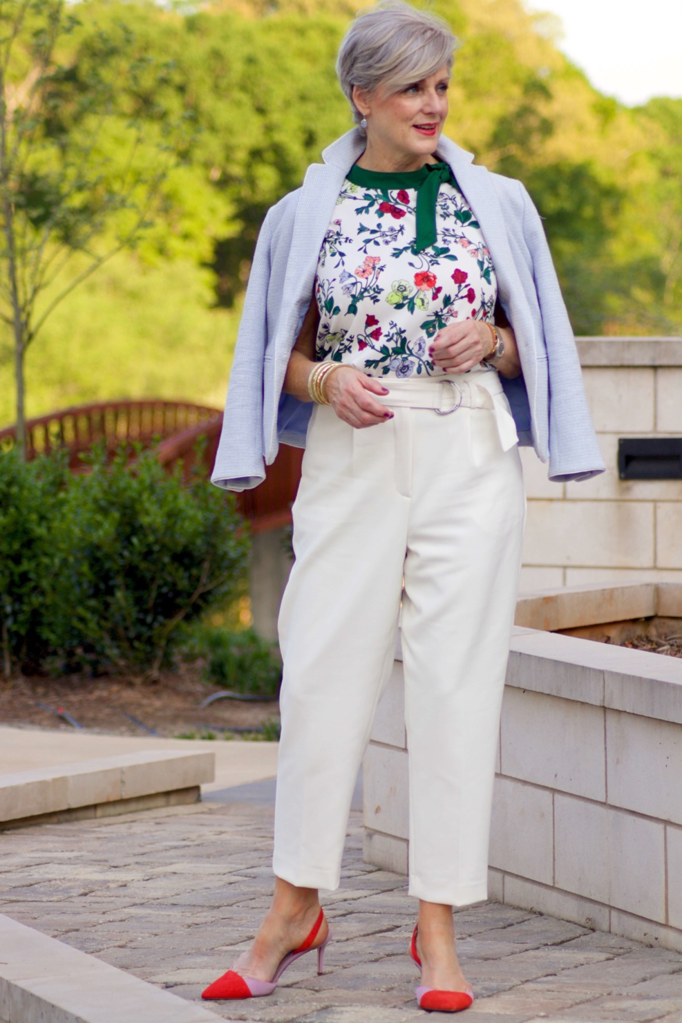 beth from Style at a Certain Age wears Ann Taylor floral sleeveless tie neck blouse, pleated pants, textured blazer, and suede slingbacks