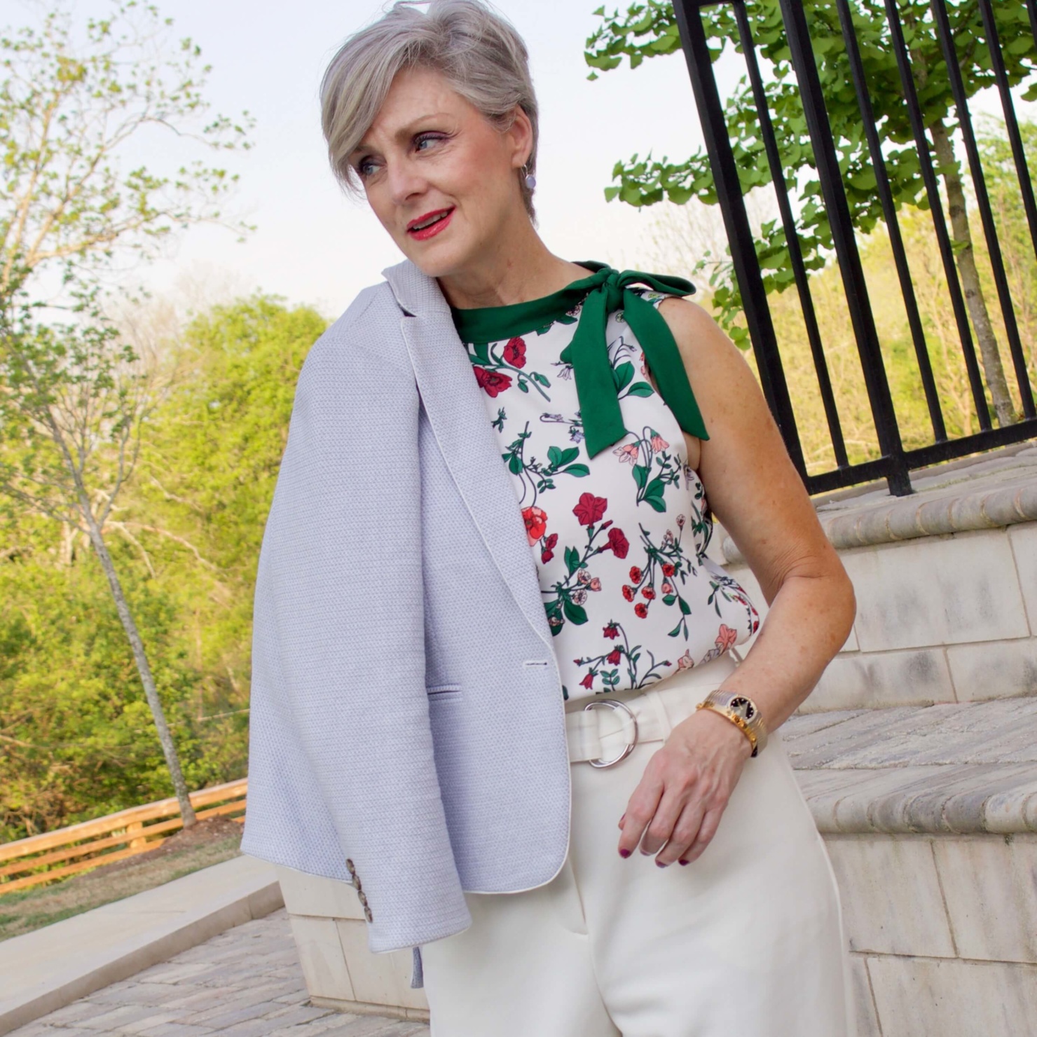beth from Style at a Certain Age wears a textured blazer and floral sleeveless blouse