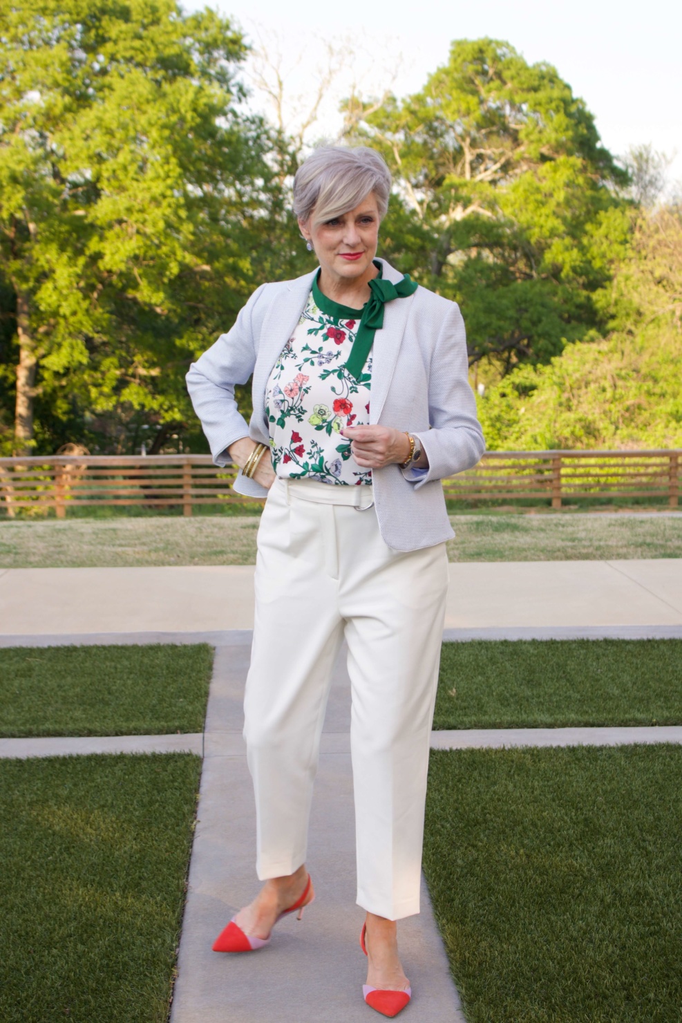 beth from Style at a Certain Age wears Ann Taylor floral sleeveless tie neck blouse, pleated pants, textured blazer, and suede slingbacks
