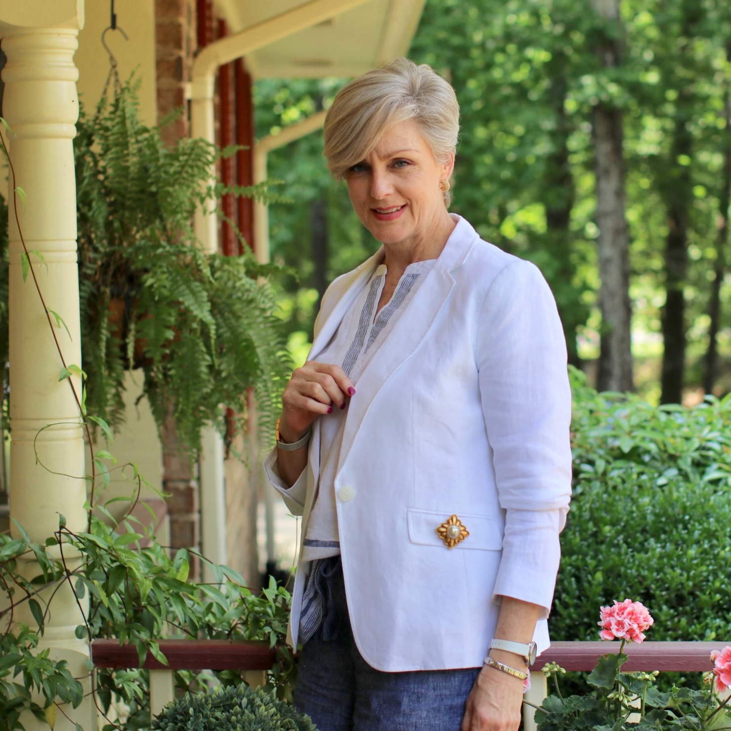 beth from Style at a Certain Age wears a classic summer blazer, drawstring shorts, seersucker sandals, and striped linen top