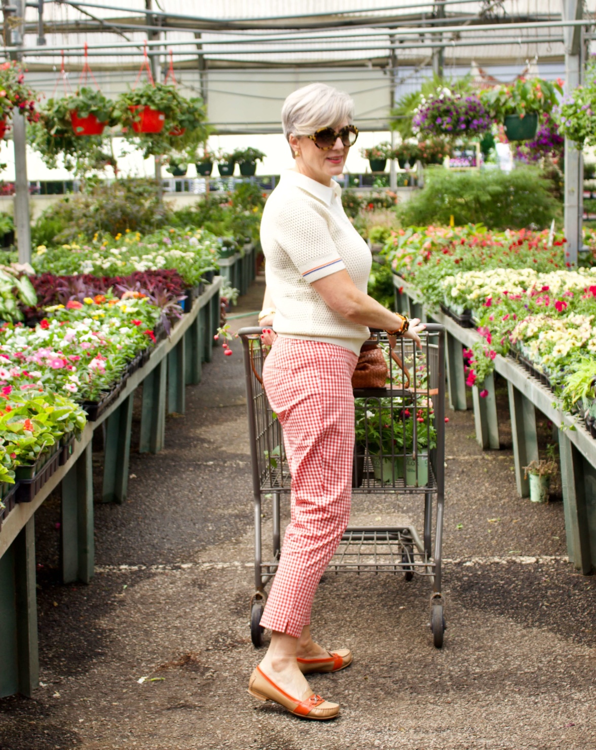beth from Style at a Certain Age wears a Tory Burch short sleeve sweater, gingham pants, and Cole Haan loafers