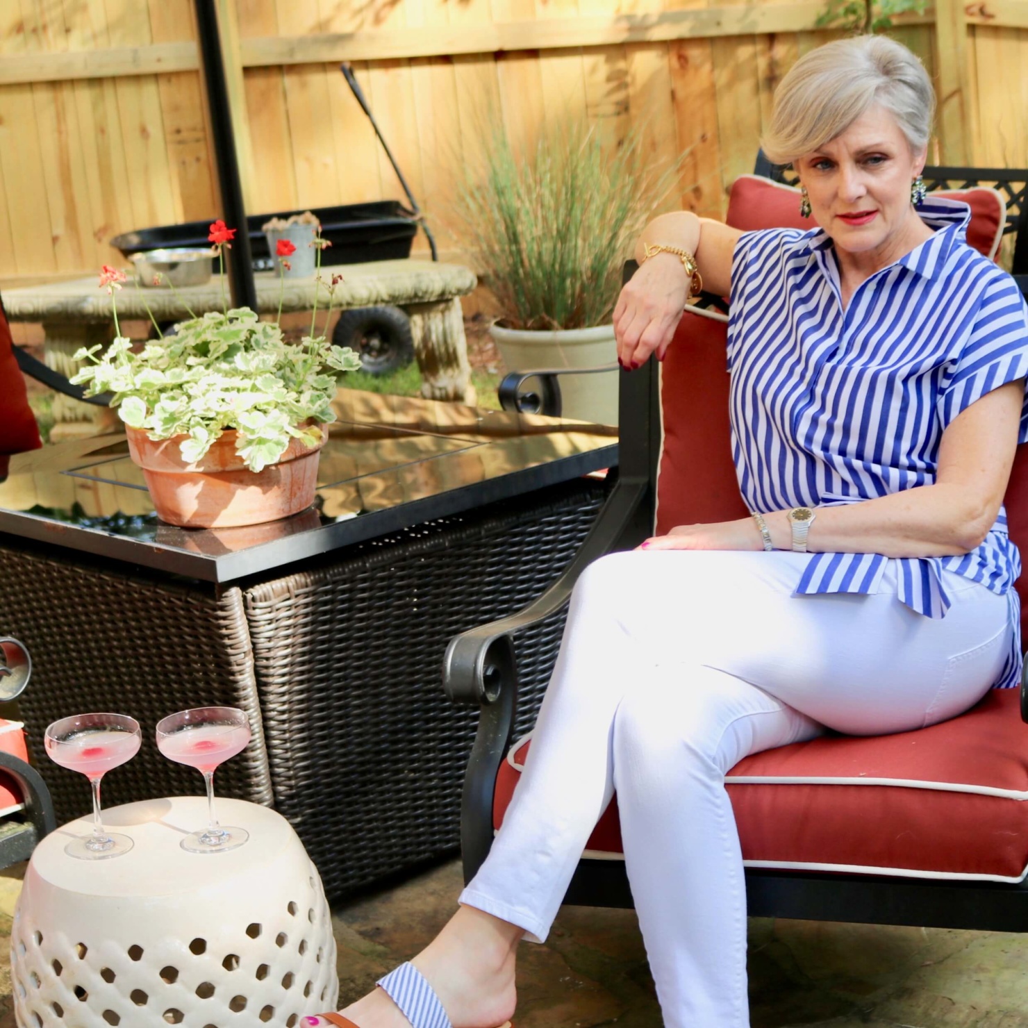 beth from Style at a Certain Age wears a striped shirt, white denim, and seersucker sandals