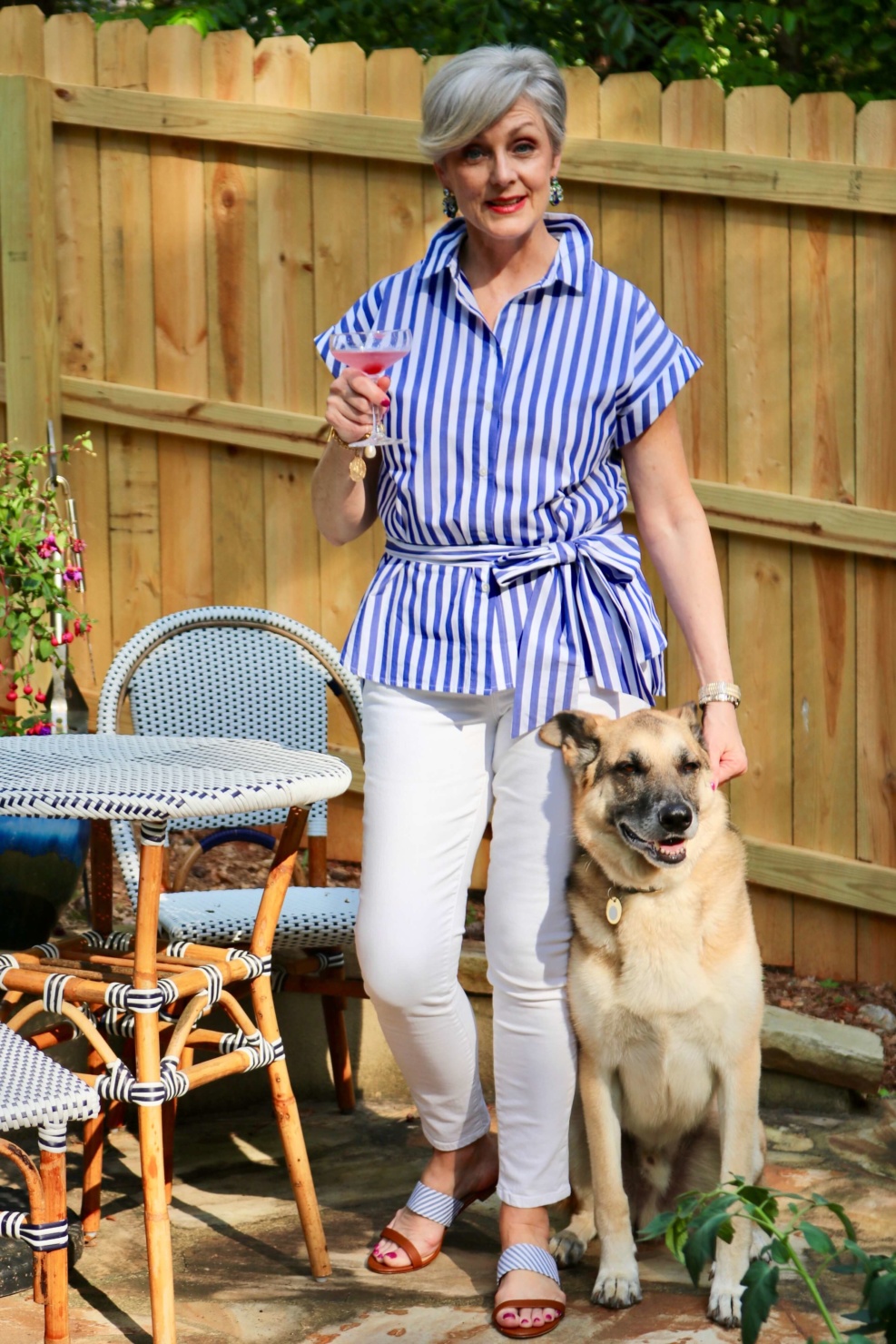 beth from Style at a Certain Age wears a striped shirt, white denim, and seersucker sandals