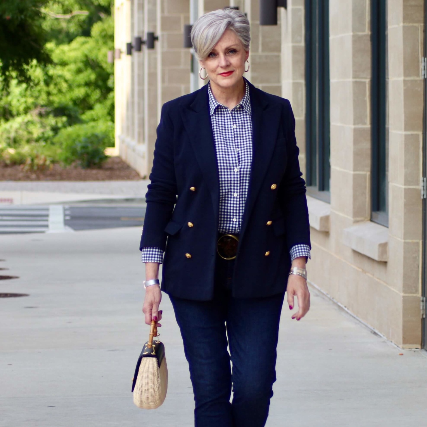 beth from Style at a Certain Age wears a lightweight blazer, gingham shirt, skinny jeans, espadrilles and wicker handbag
