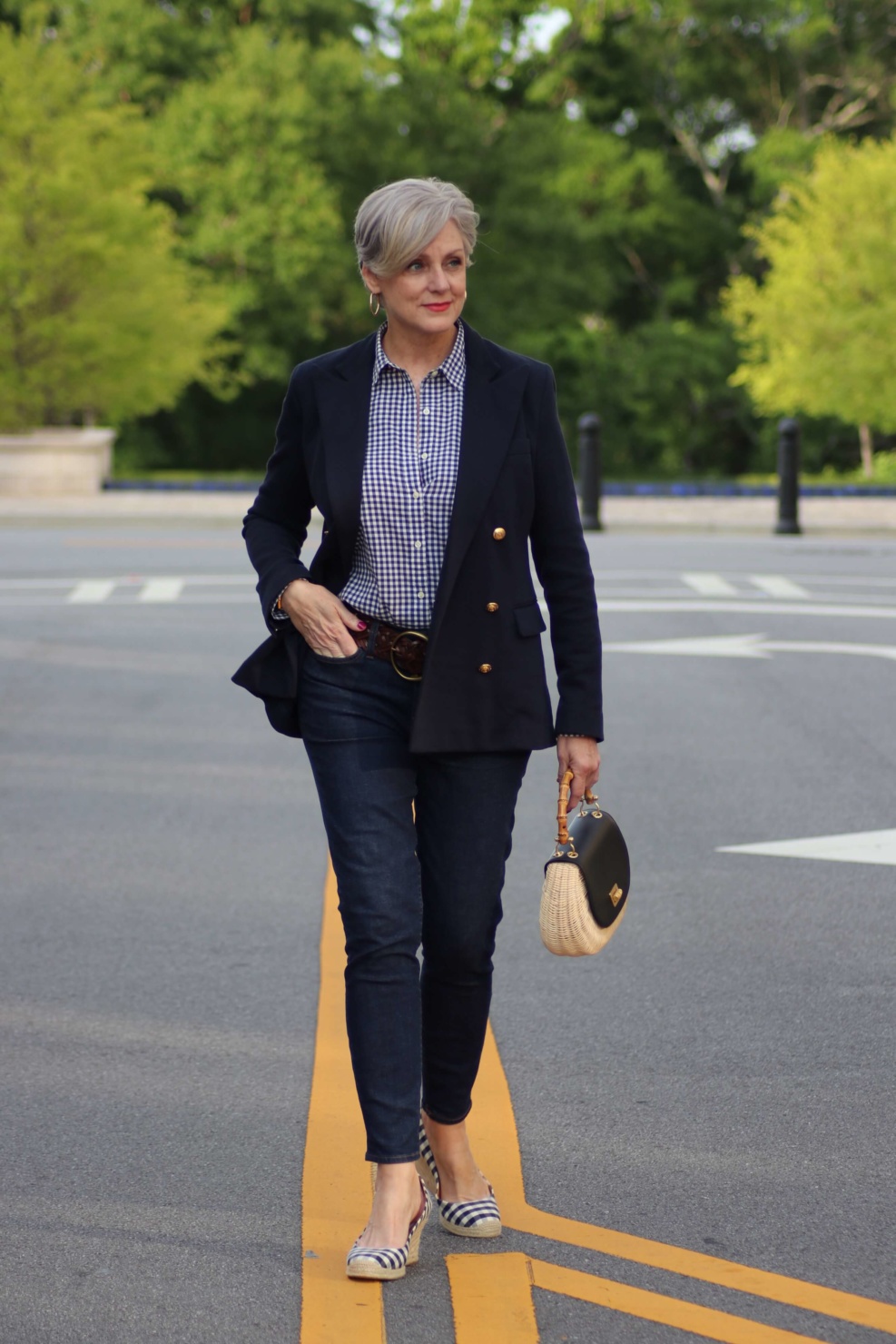 beth from Style at a Certain Age wears a lightweight blazer, gingham shirt, skinny jeans, espadrilles and wicker handbag