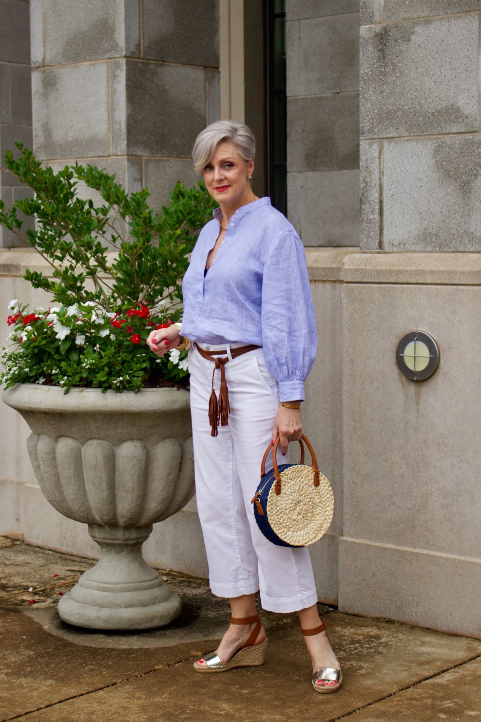 cropped white denim, striped linen shirt, cornhusk handbag, and wedge sandals