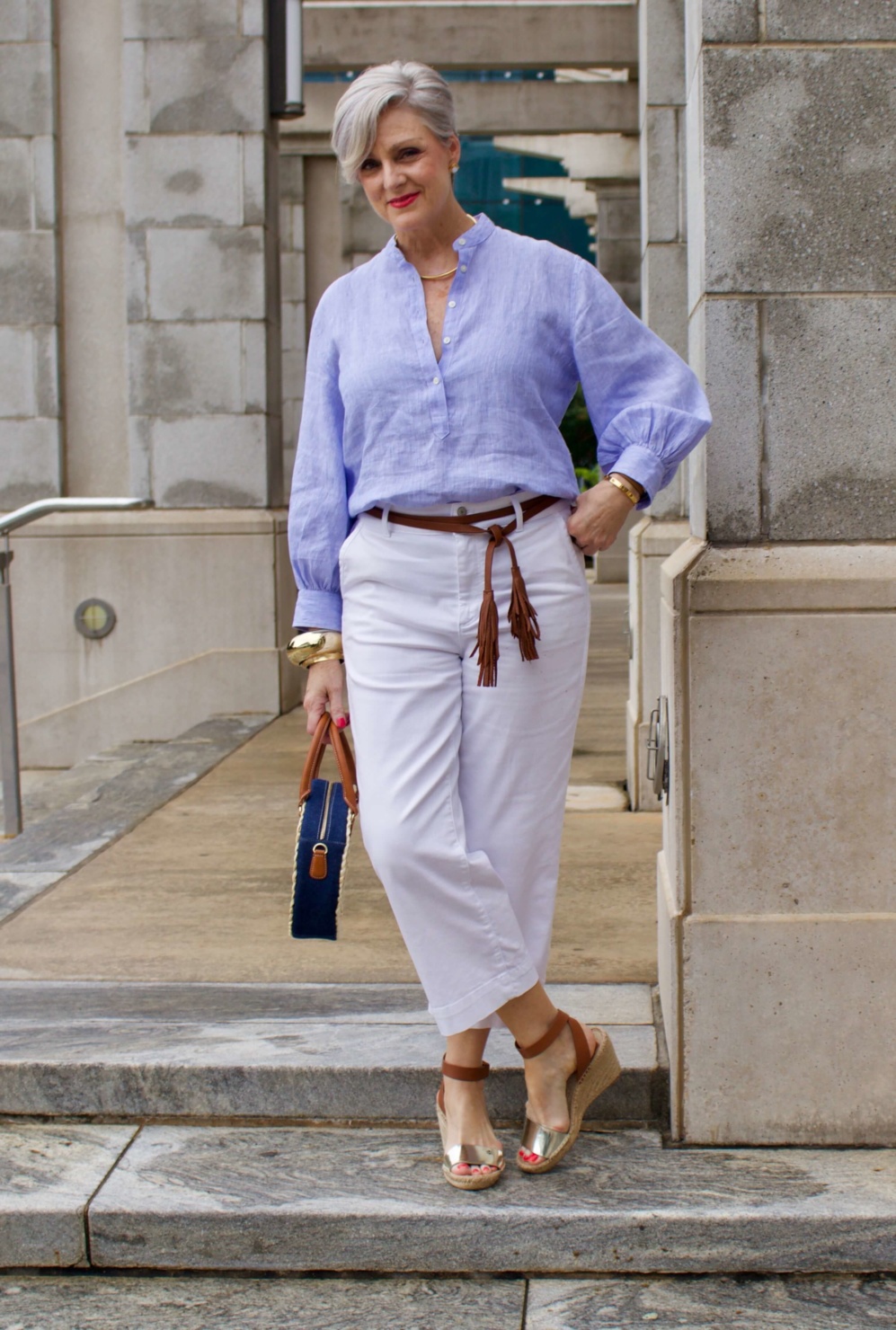 cropped white denim, striped linen shirt, cornhusk handbag, and wedge sandals