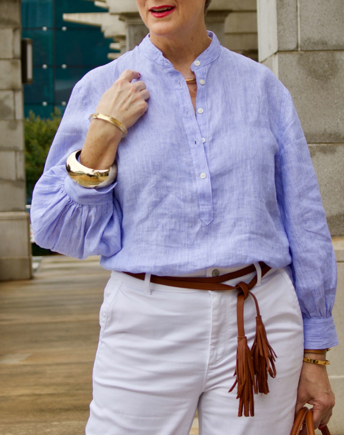 cropped white denim, striped linen shirt, cornhusk handbag, and wedge sandals