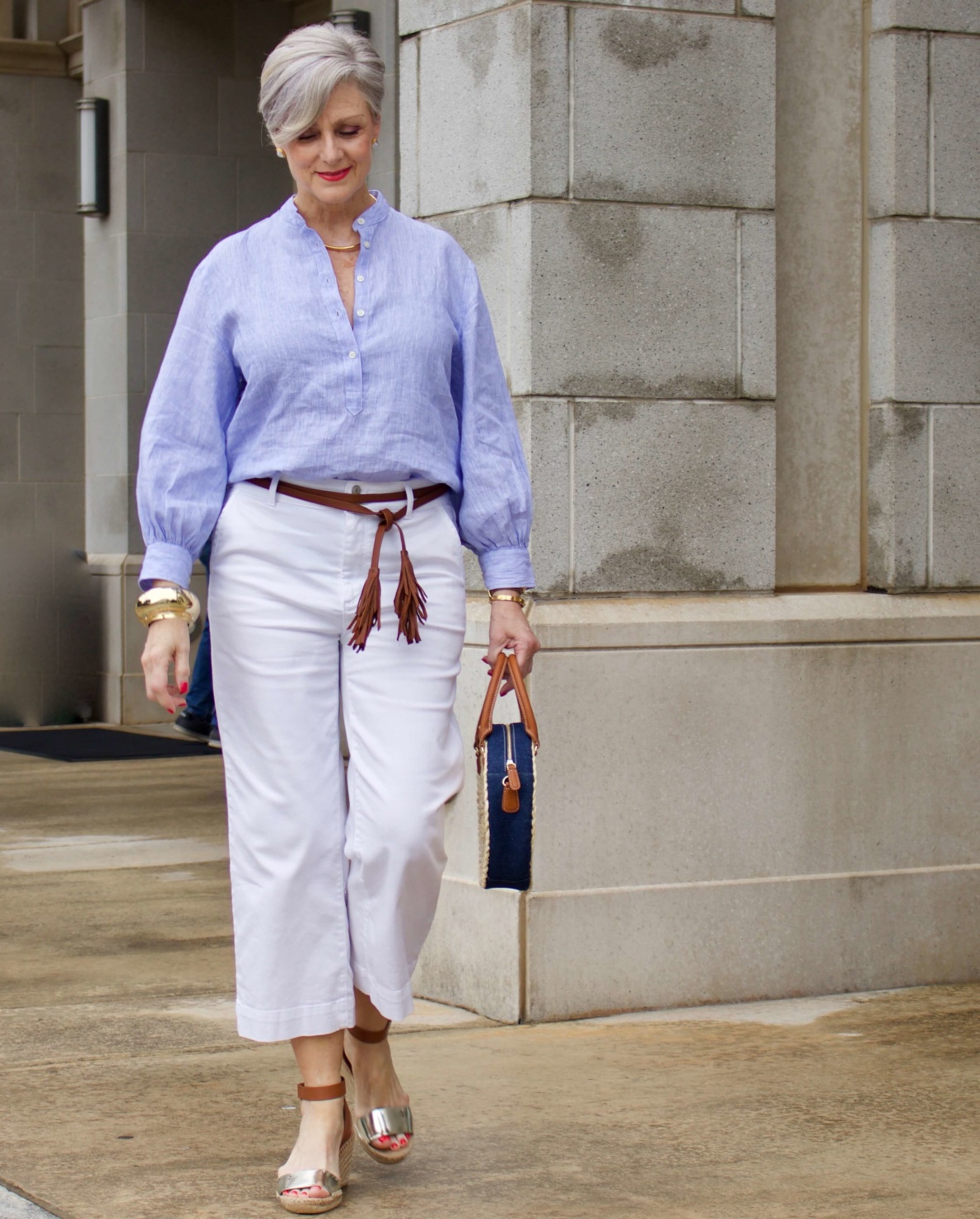 cropped white denim, striped linen shirt, cornhusk handbag, and wedge sandals