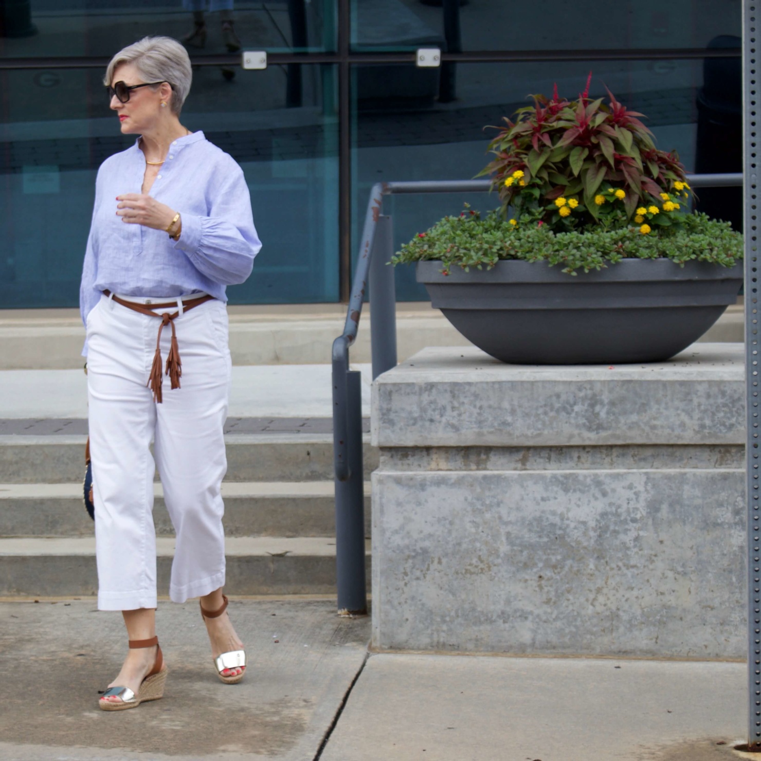 cropped white denim, striped linen shirt, cornhusk handbag, and wedge sandals