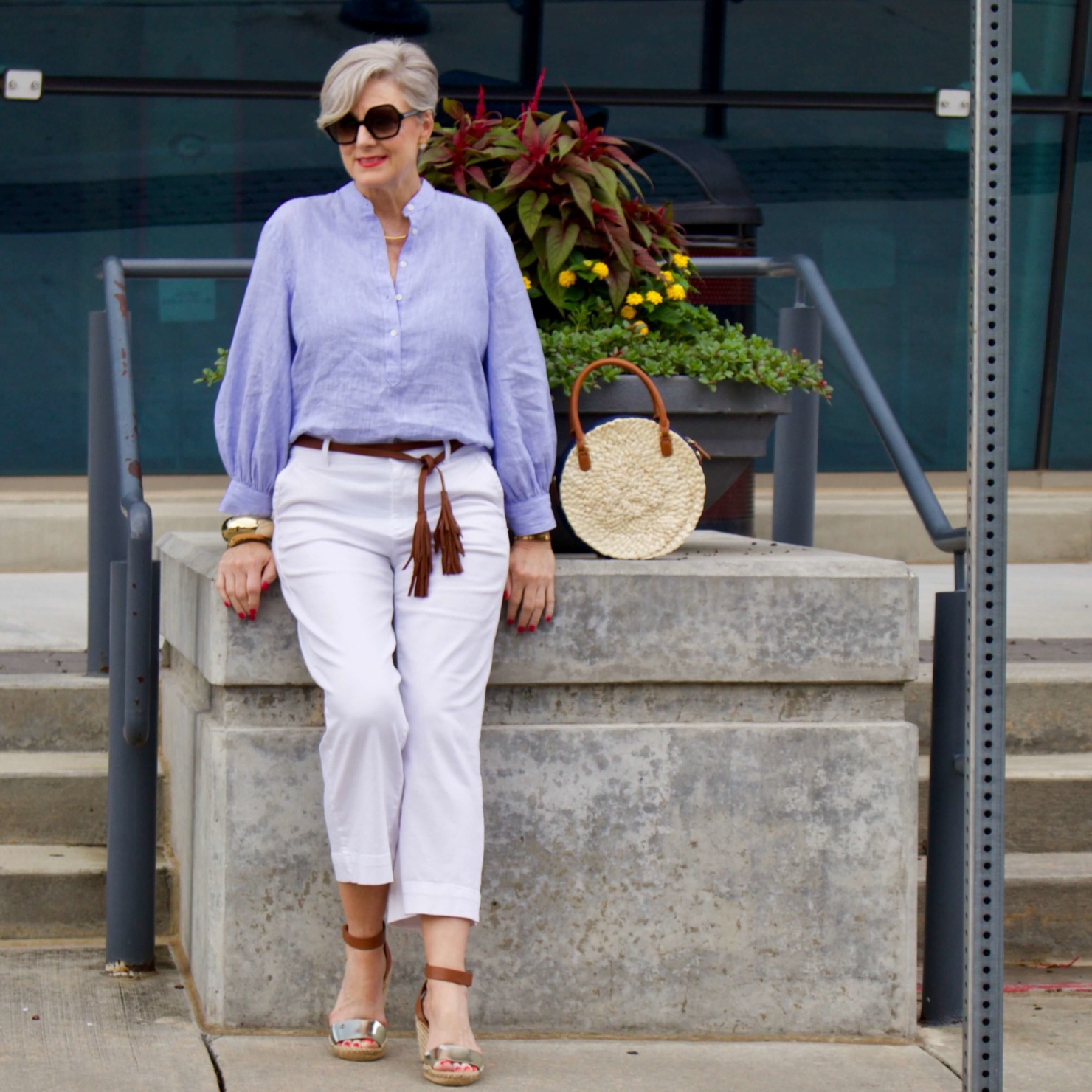 cropped white denim, striped linen shirt, cornhusk handbag, and wedge sandals