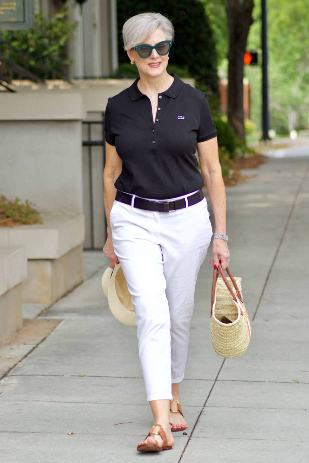 lacoste black polo, white chinos, brown sandals, straw tote