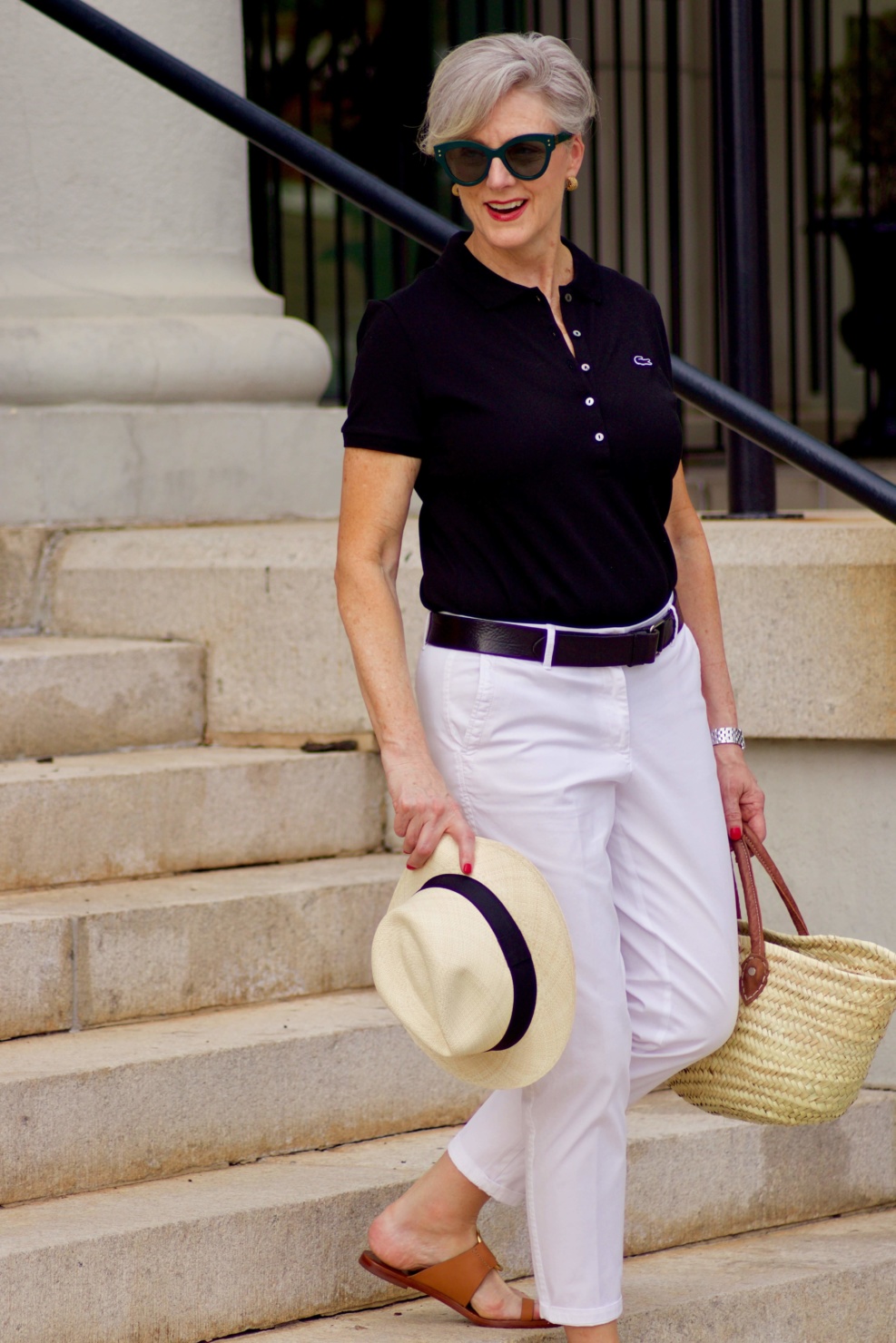 lacoste black polo, white chinos, brown sandals, straw tote