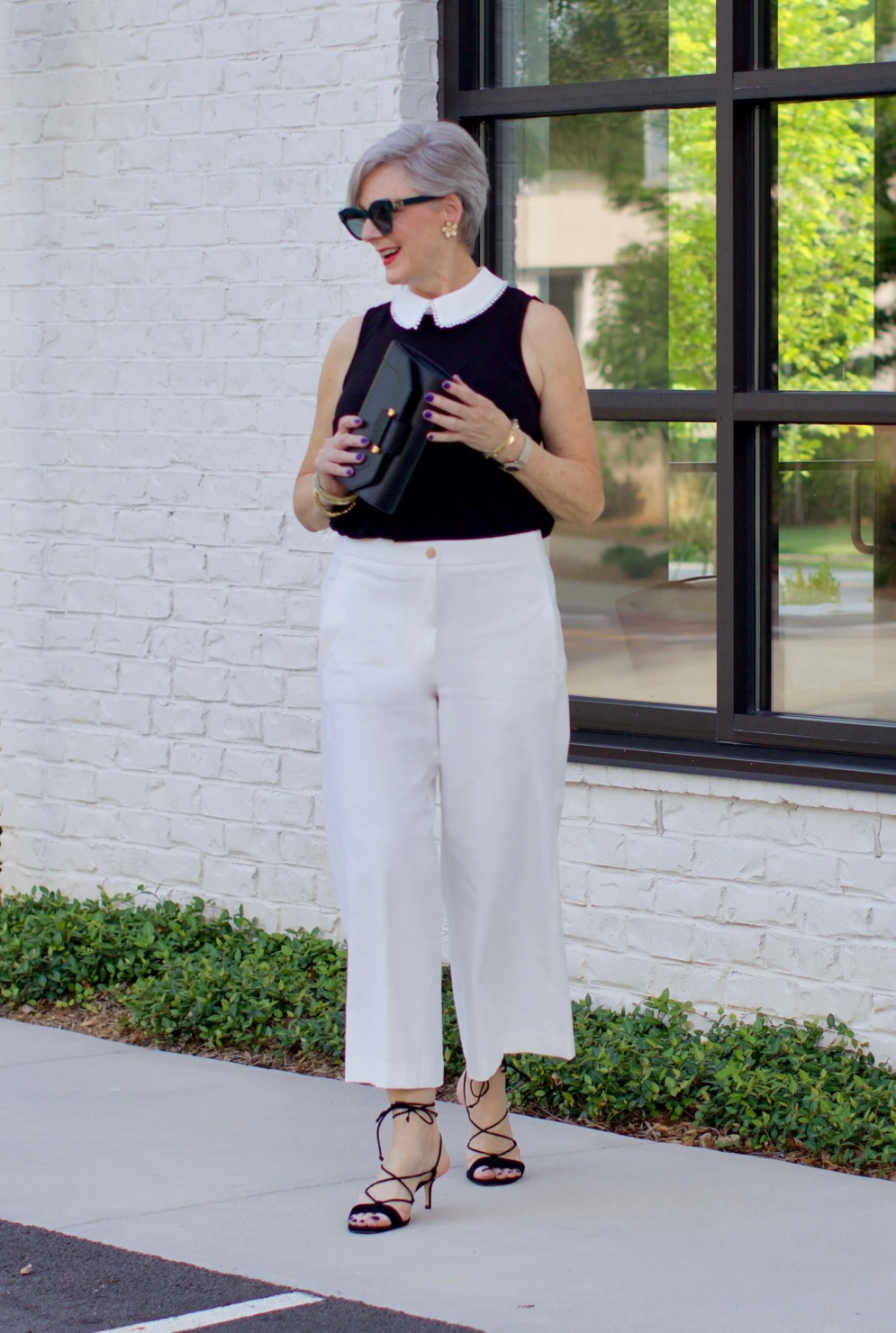 what to wear to work wide leg pants, black blouse, and suede sandals