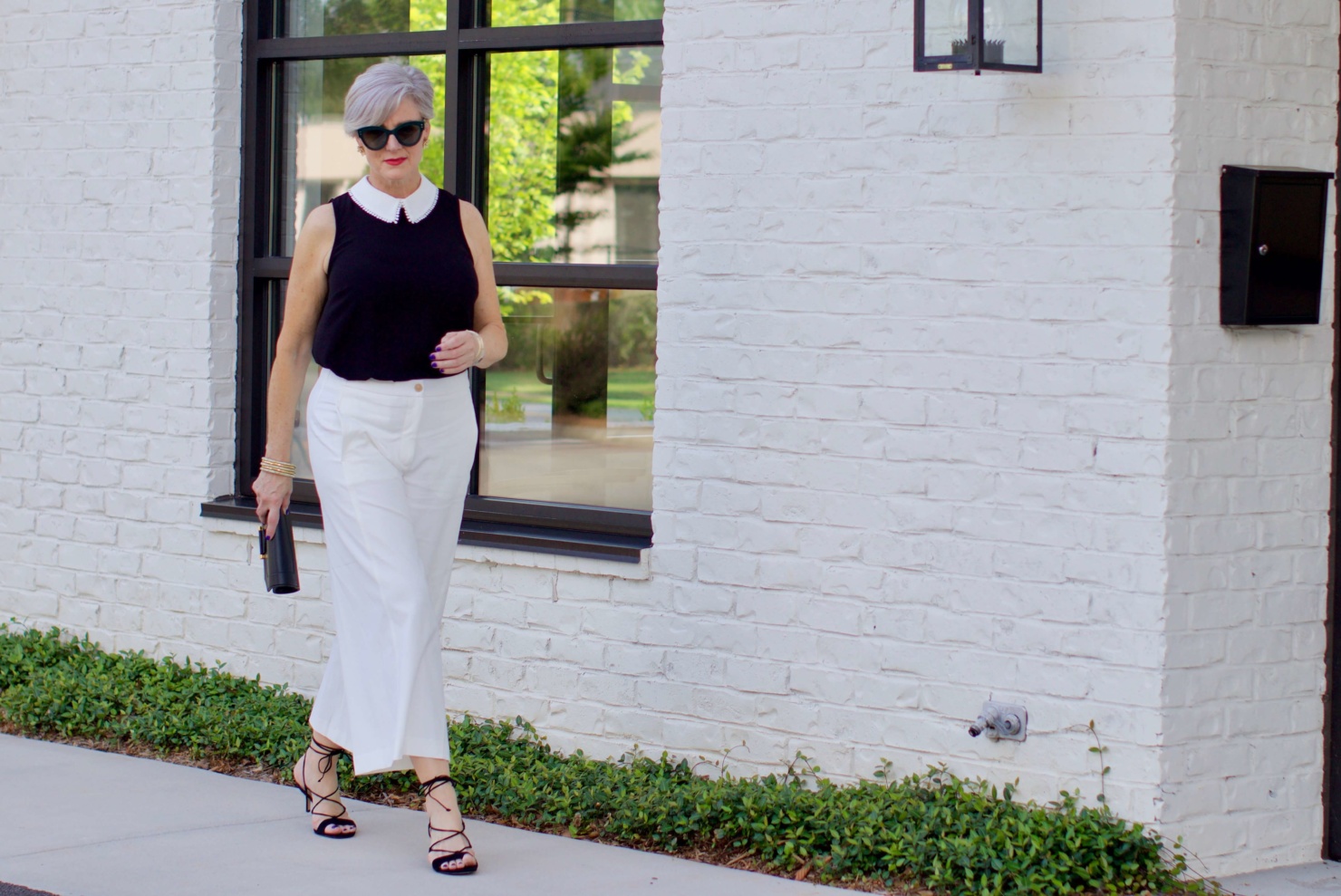 what to wear to work wide leg pants, black blouse, and suede sandals