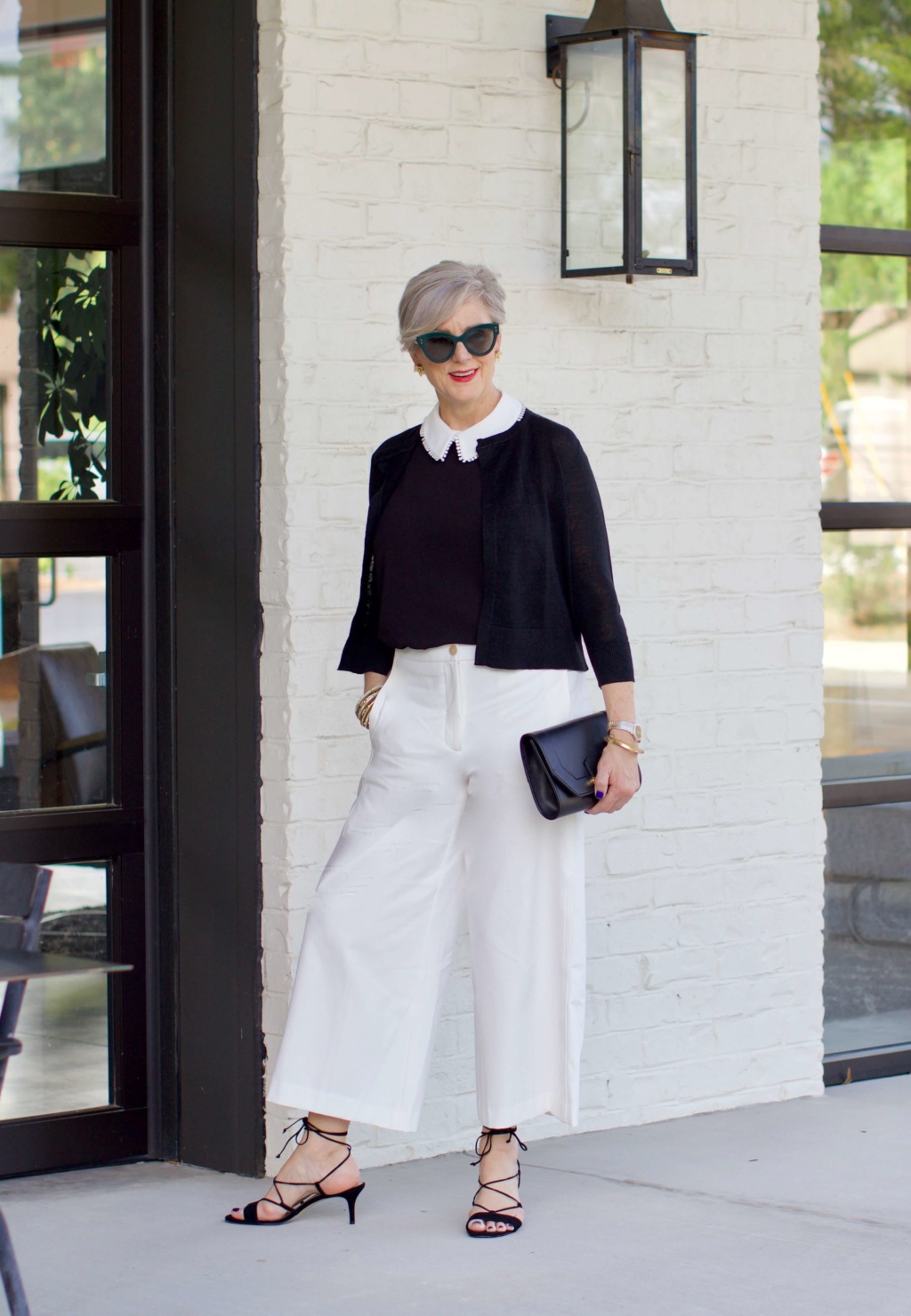 what to wear to work wide leg pants, black blouse, and suede sandals