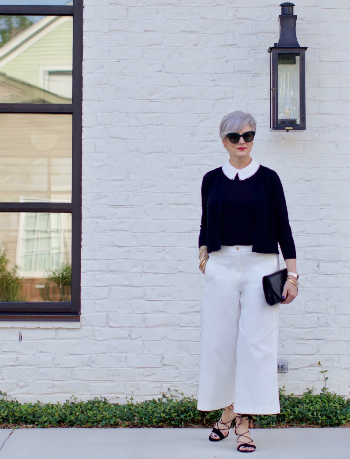 what to wear to work wide leg pants, black blouse, and suede sandals