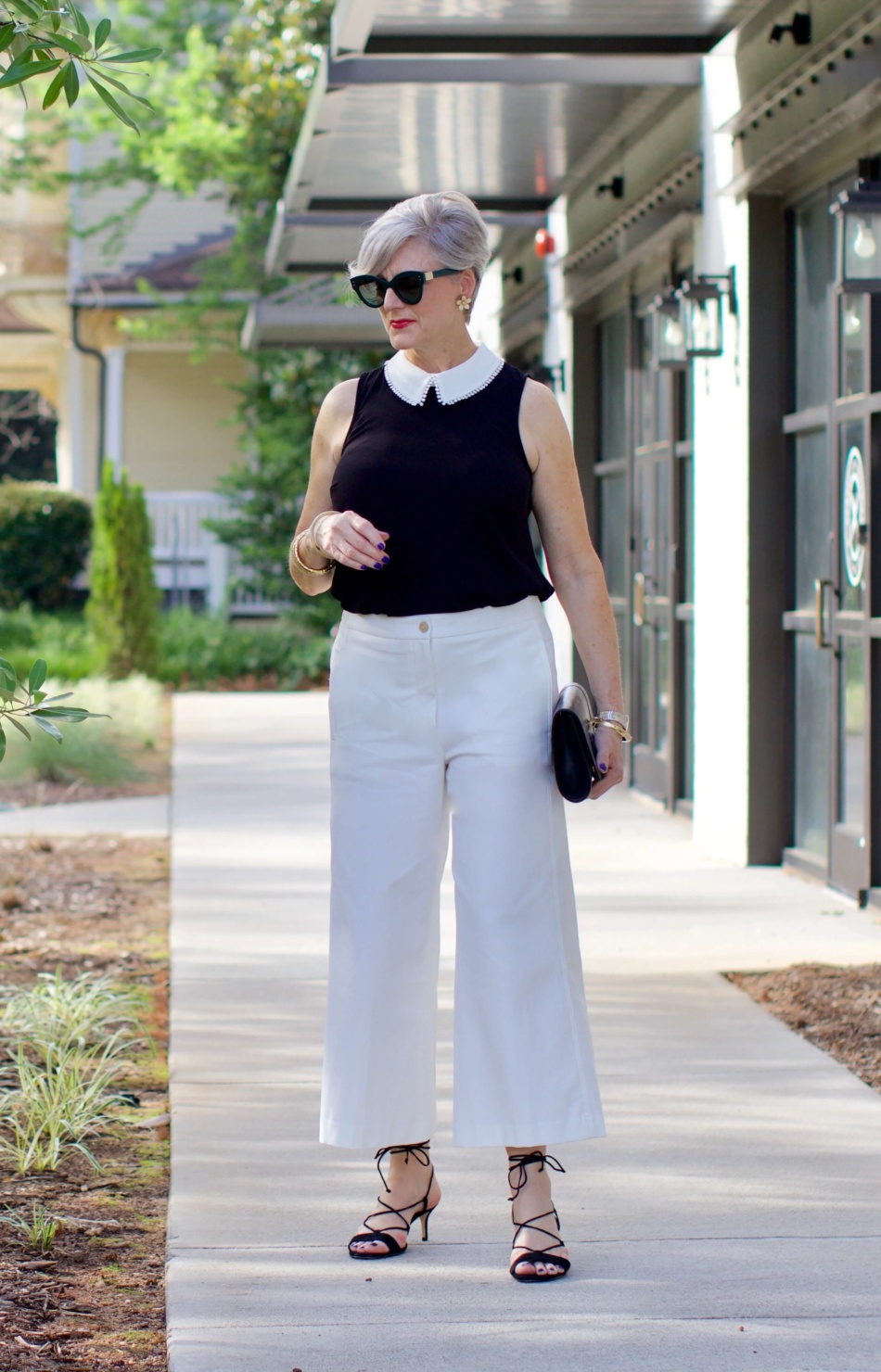 what to wear to work wide leg pants, black blouse, and suede sandals