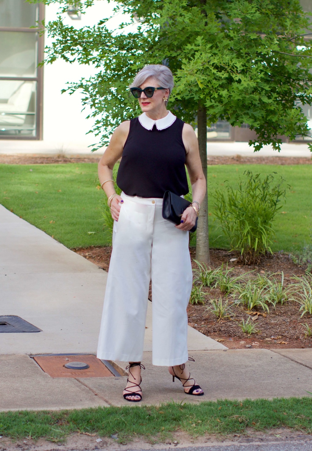 what to wear to work wide leg pants, black blouse, and suede sandals