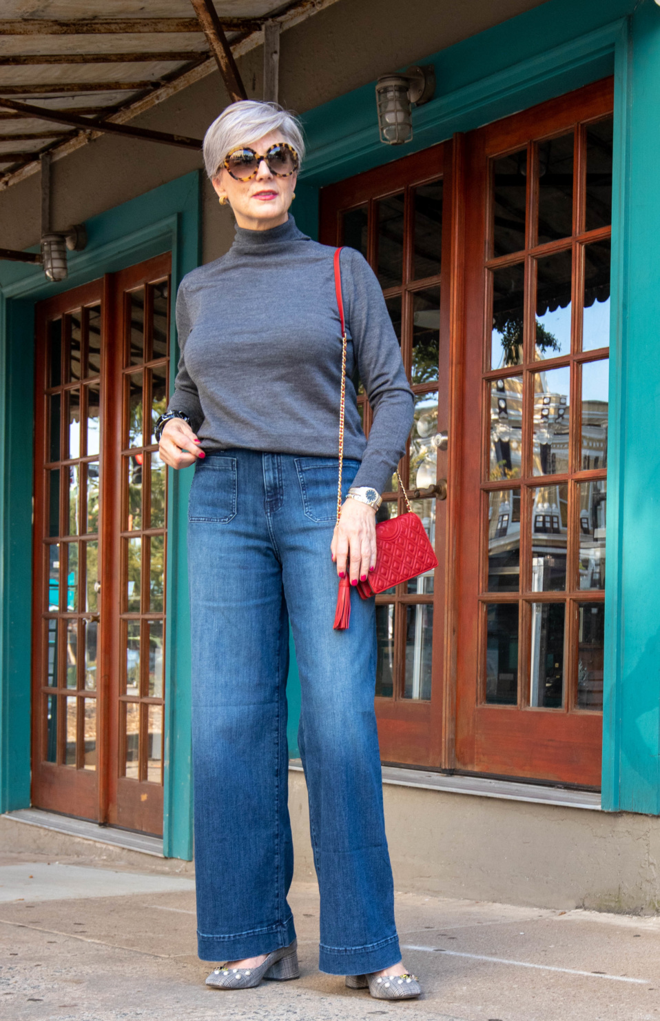 wide leg jeans, gray turtleneck, red handbag