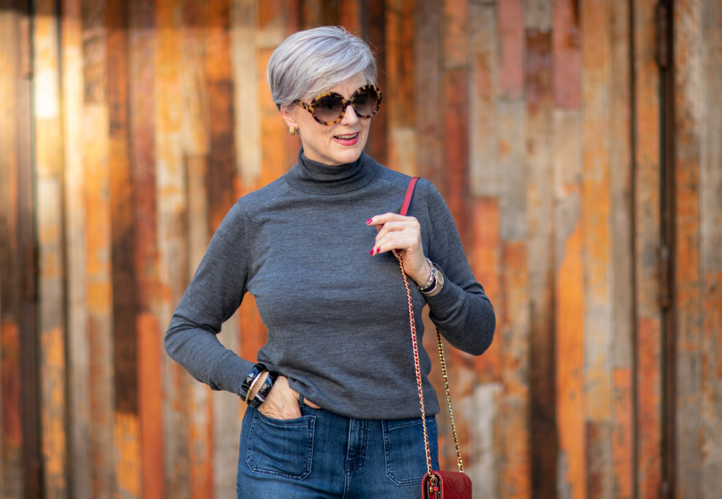 wide leg jeans, gray turtleneck, red handbag