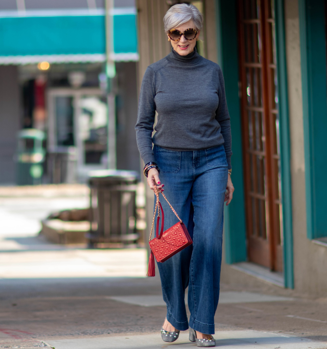wide leg jeans, gray turtleneck, red handbag