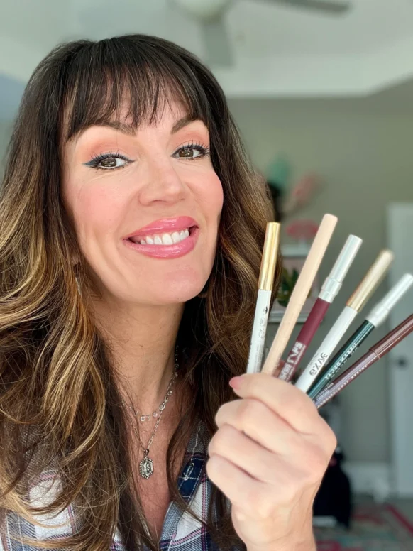Jennifer holds a variety of eyeliner pencils