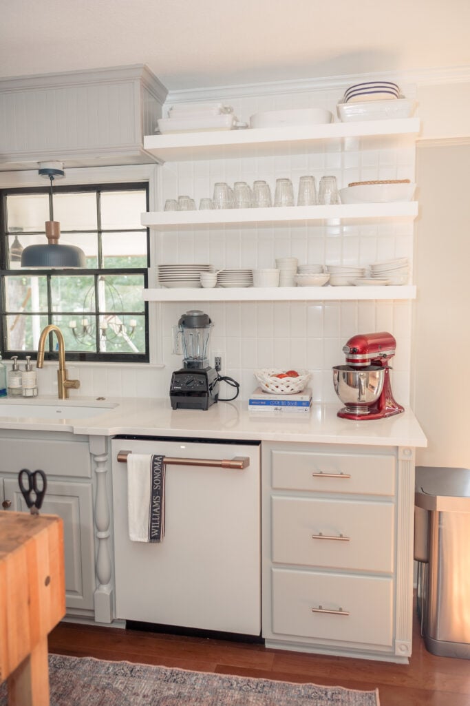 White open shelving with everyday dishes and glassware — practical and timeless 2025 kitchen remodel idea.